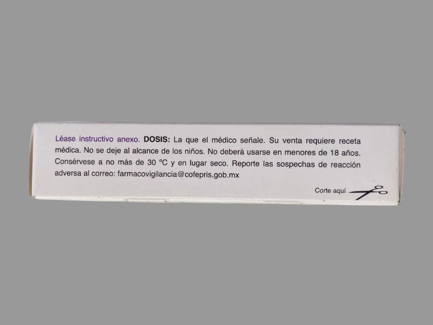 Small white box with text on a gray surface