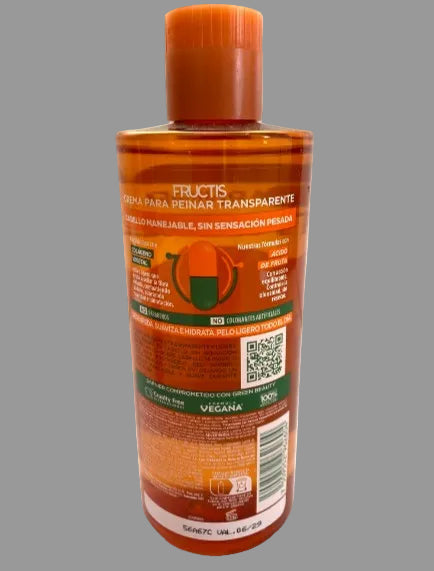 A bottle of Fructis clear skin marker for peachy skin, shown from the back on a white background. The bottle is transparent amber-brown with a matching orange cap, featuring product details, a QR code, and a barcode on the label.