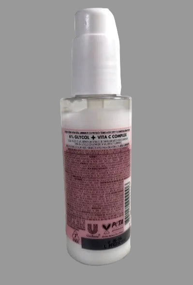 Skincare serum bottle with pink label on a white background