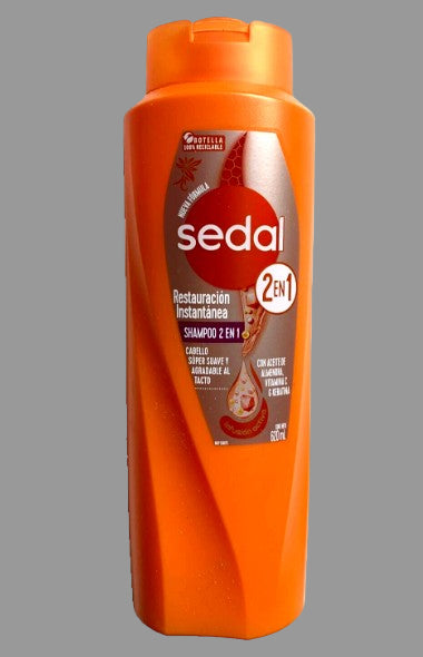 A bottle of Sedal Restauracion Instantanea 2X1 Shampoo&Conditioner in orange packaging.
