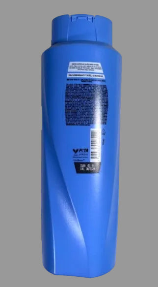 Blue shampoo bottle on a gray background