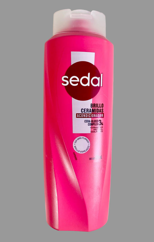 Pink shampoo bottle with 'sedal' branding on a light gray background