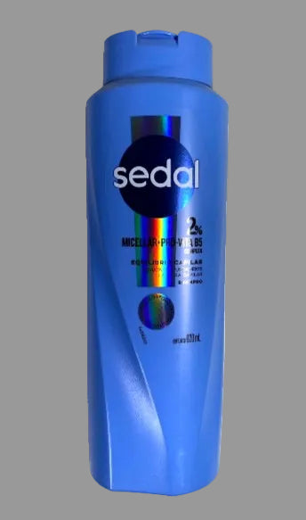 Blue bottle of Sedal shampoo with colorful label on a white background